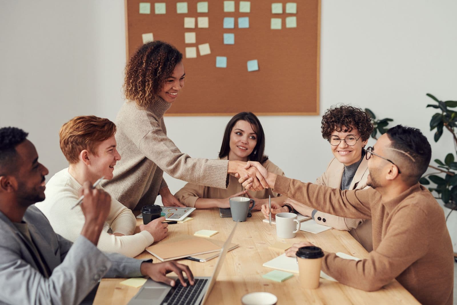 Admissions and leadership teams closing a discussion with a handshake