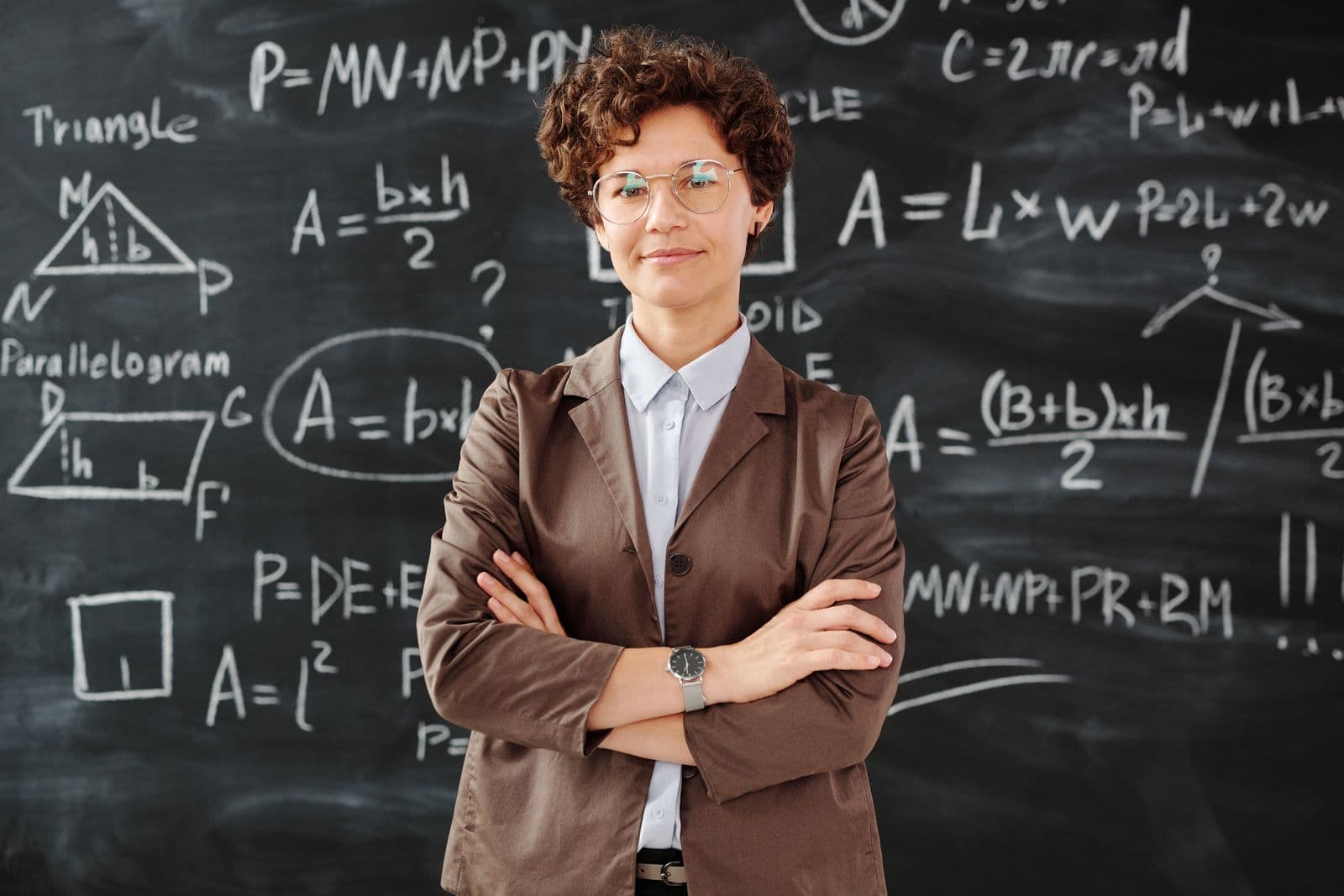 An instructor standing in front of a classroom chalkboard