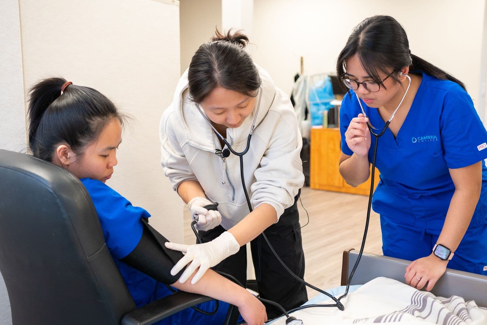 Nursing students practicing blood-pressure measurement
